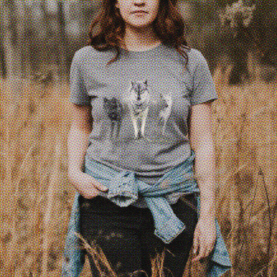 Woman wearing a T-shirt with 3 wolves on printed on it